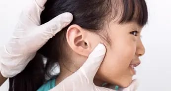 children undergoing ear checking