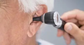 elderly getting ear checked