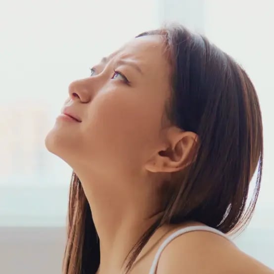 happy woman looking up at ceiling