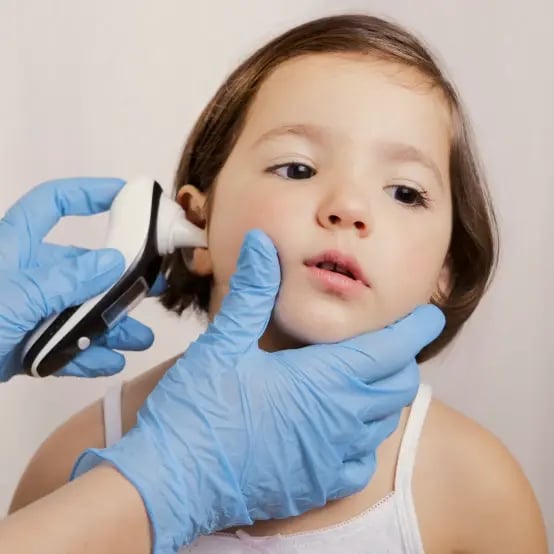 child getting their ear scanned