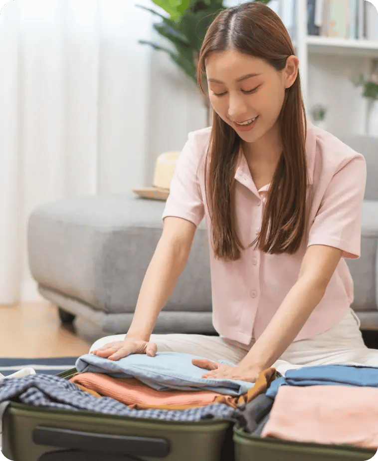 young lady packing clothes