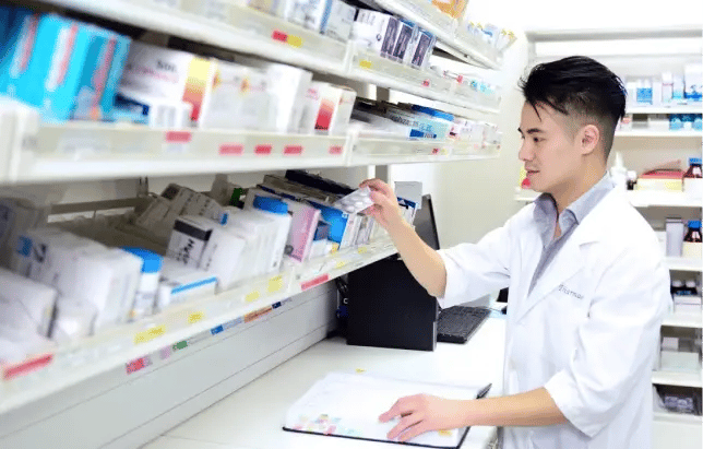 male pharmacist in pharmacy