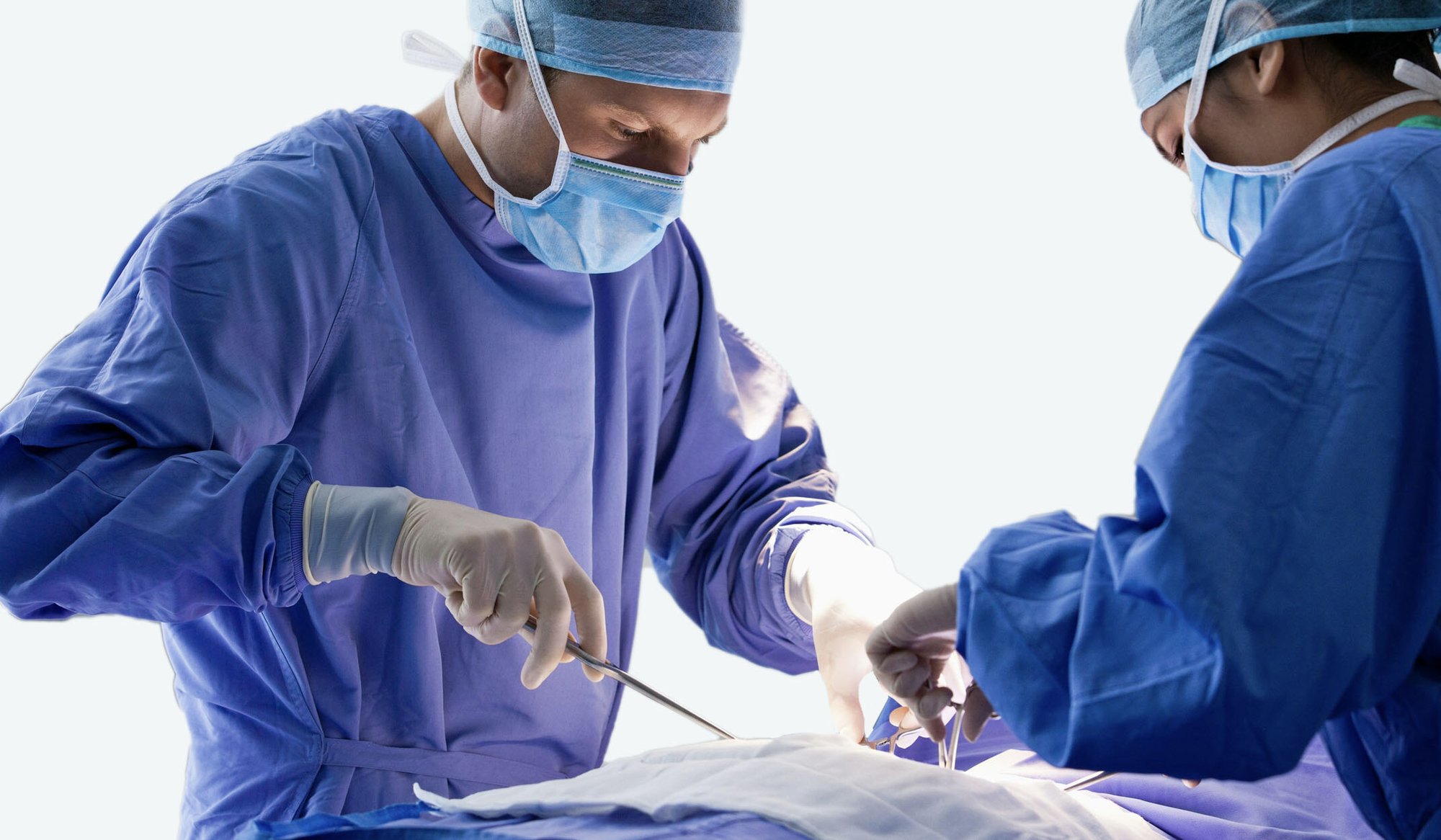 two surgeons operating on a patient